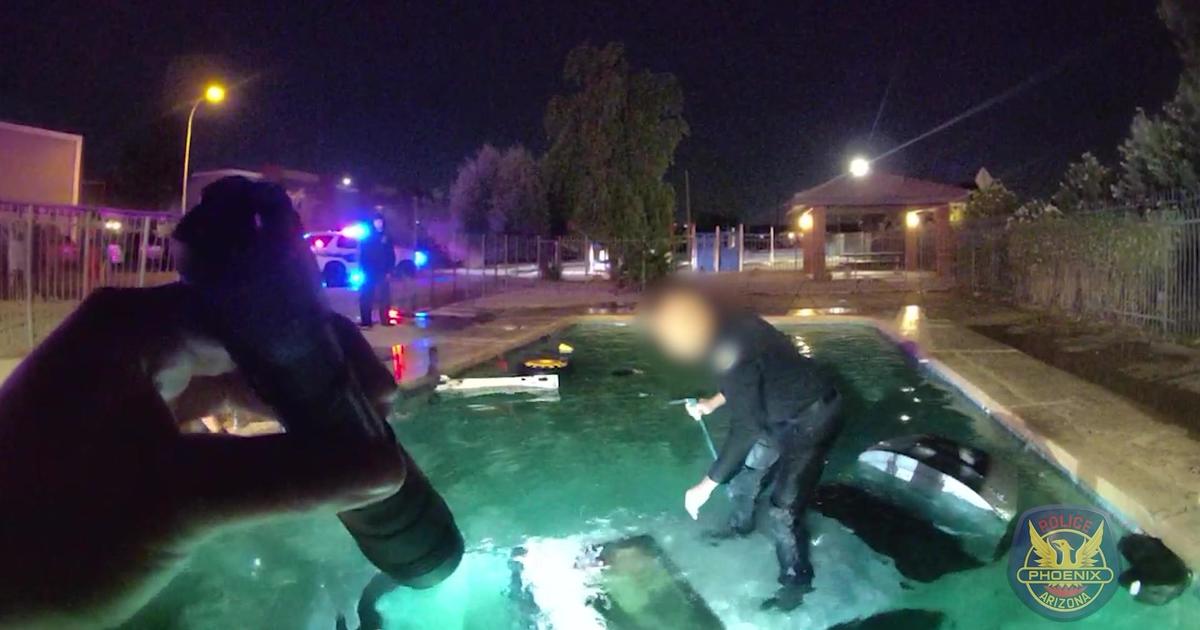 Dramatic video shows Phoenix police saving man from car submerged in pool